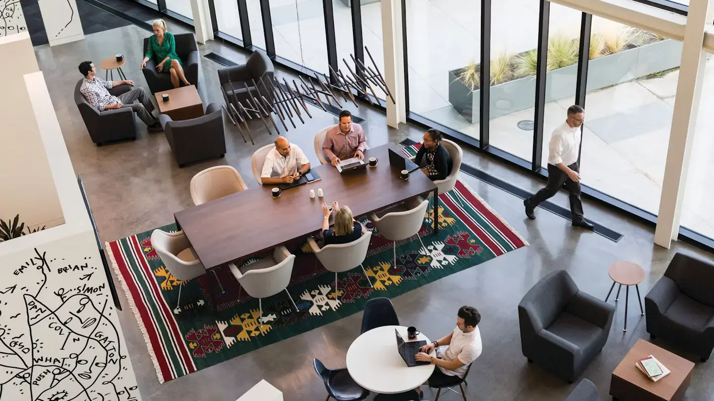 People working together around a shared table in a collaborative workplace